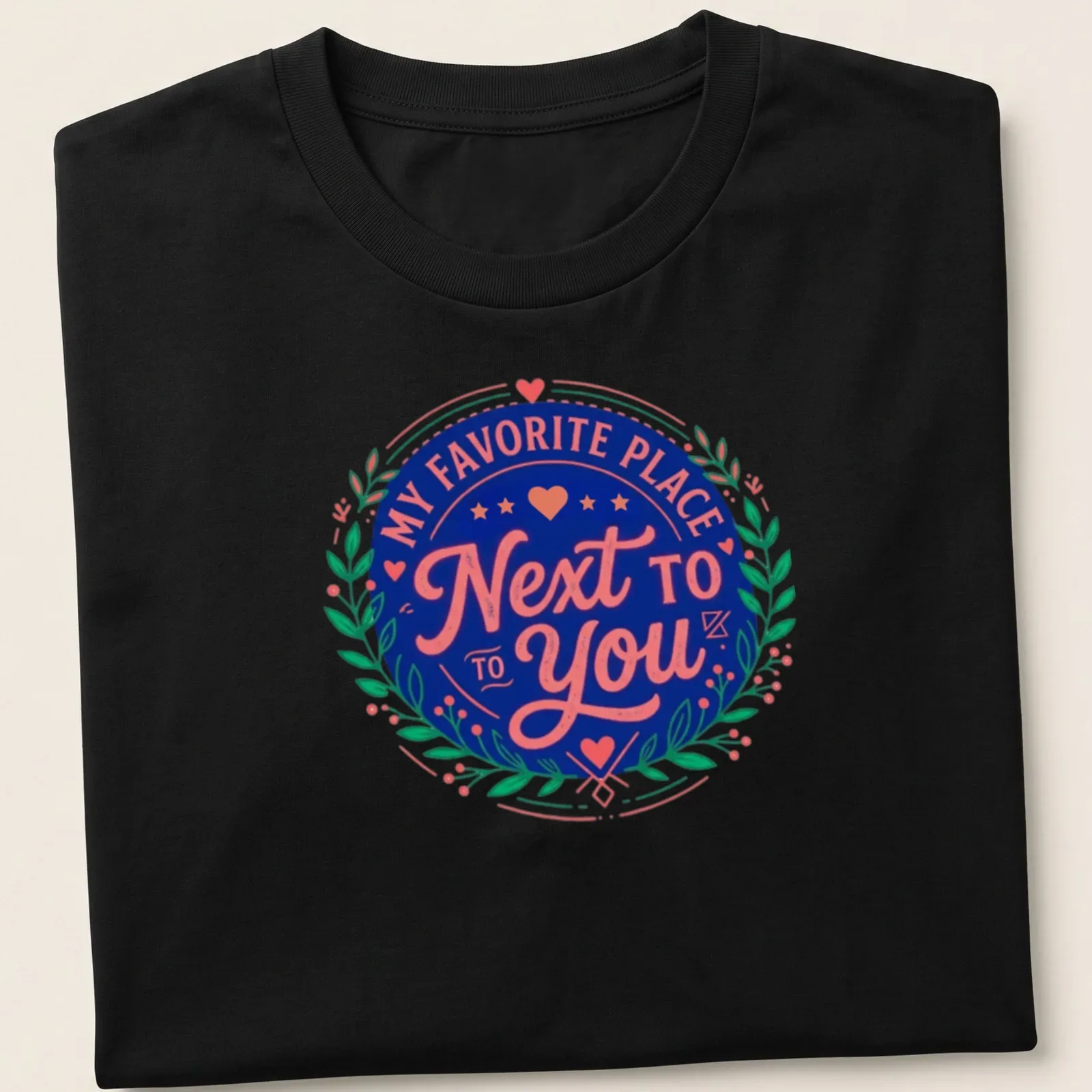Vintage badge design tee with romantic text in navy, pink, and green. — printed on a unisex t-shirt