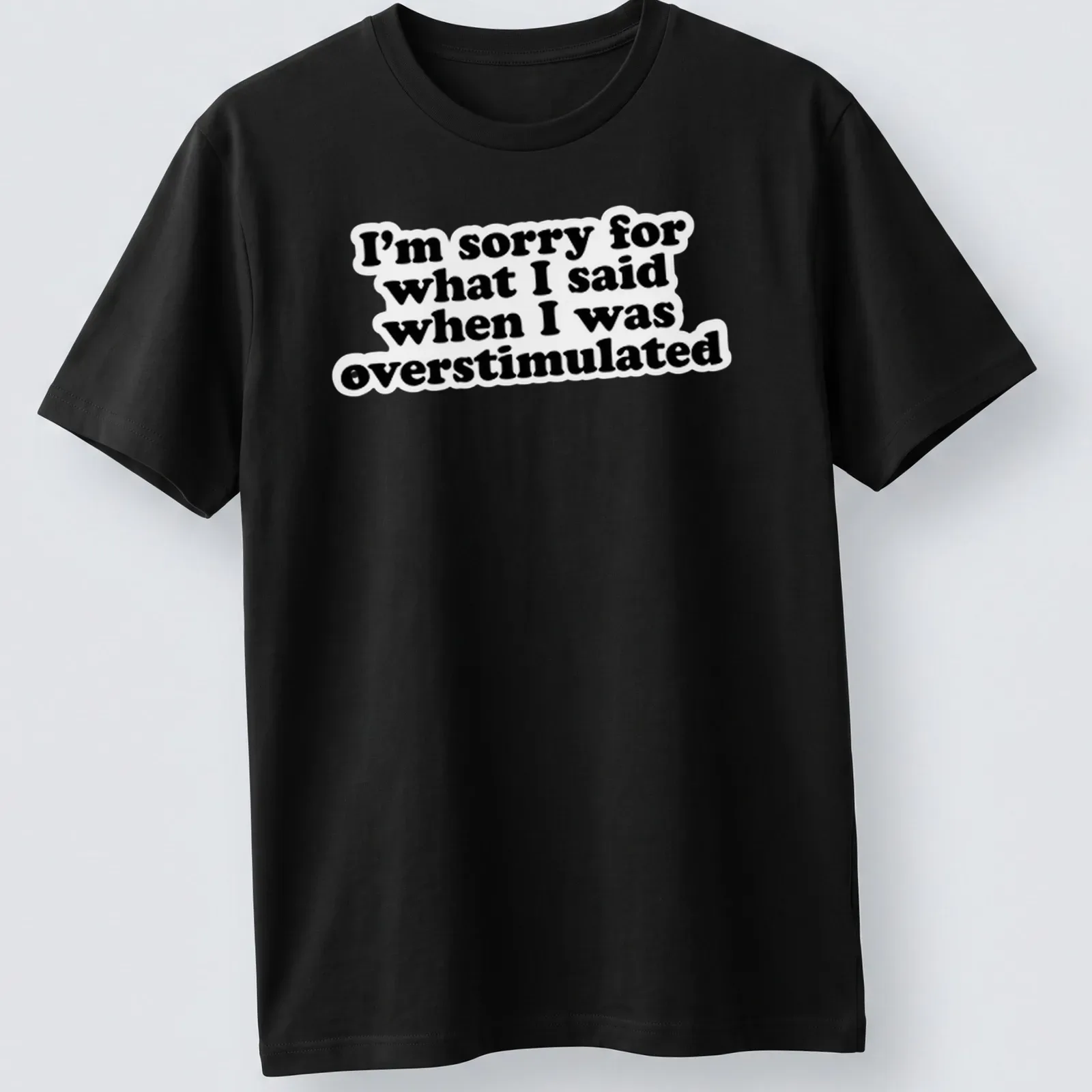 Bold typography t-shirt in black and white with an apology for overstimulation — printed on a unisex t-shirt