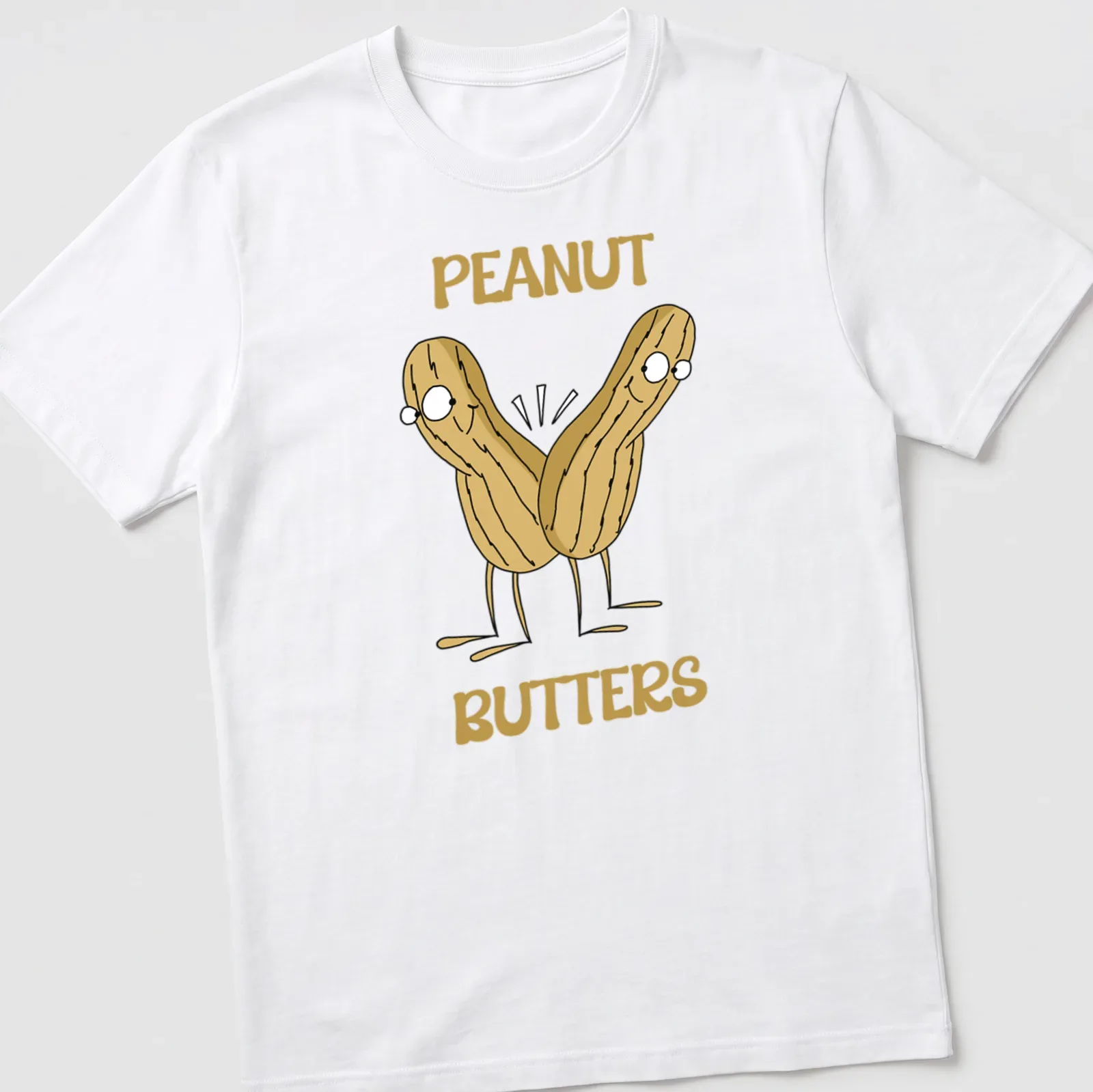 Cartoon design of peanuts with the text PEANUT BUTTERS in beige and brown — printed on a unisex t-shirt