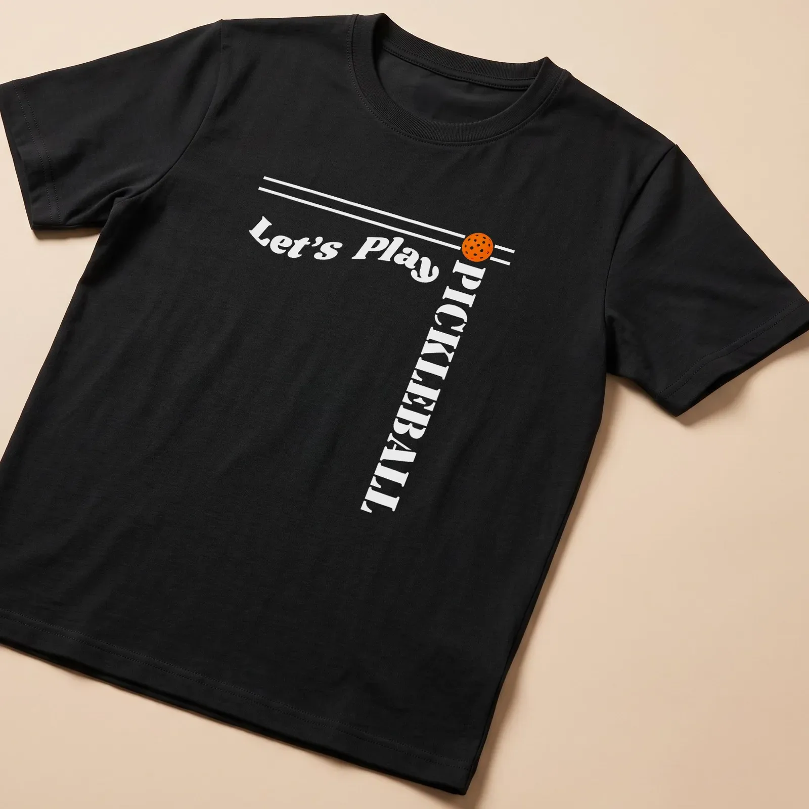 Bold modern design featuring 'Let's Play PICKLEBALL' on an orange background — printed on a unisex t-shirt