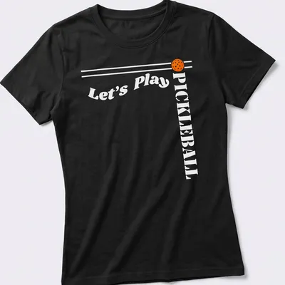 Bold modern design featuring 'Let's Play PICKLEBALL' on an orange background — printed on a women's shirt