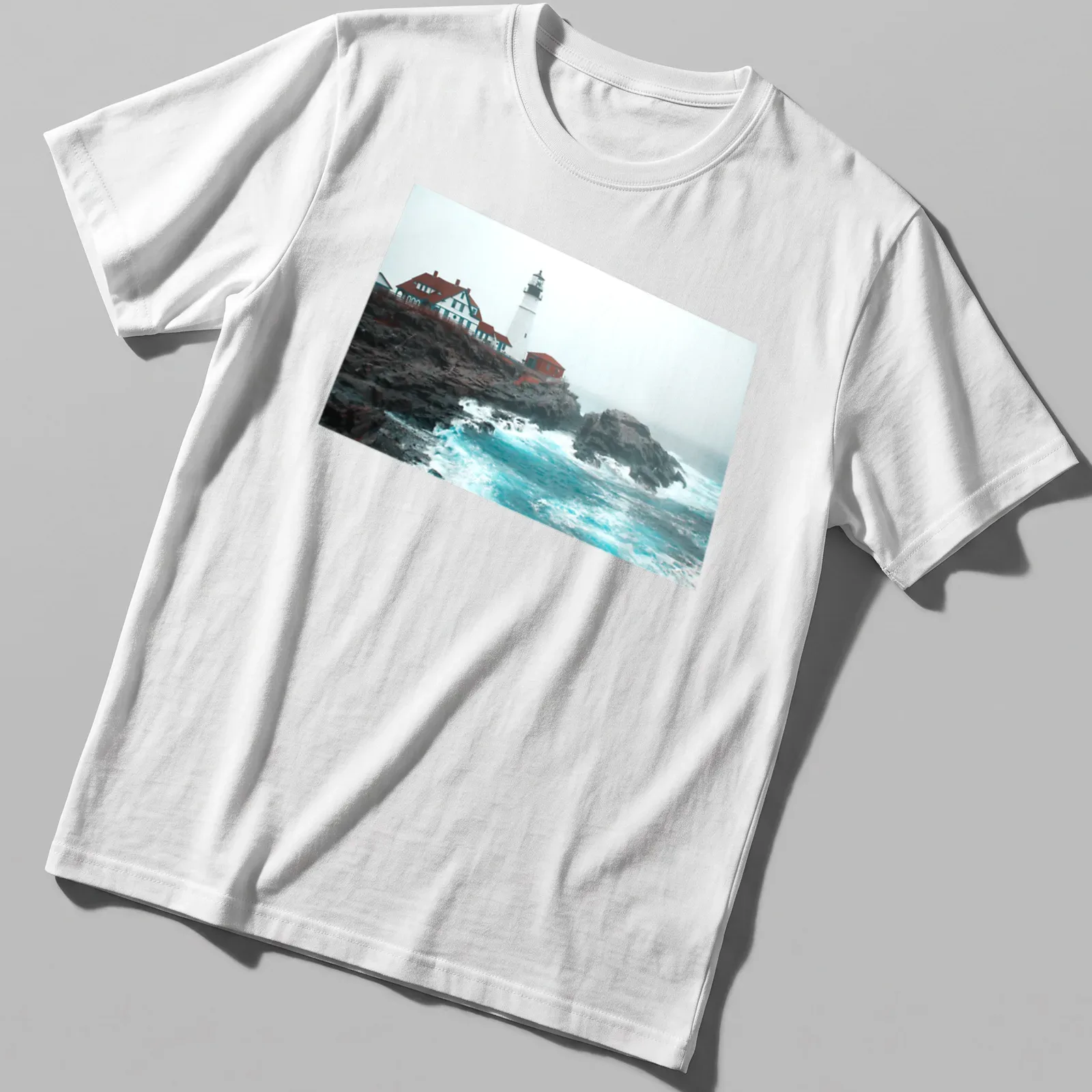 Photographic print of a lighthouse enduring ocean storm waves in blue and gray — printed on a unisex t-shirt