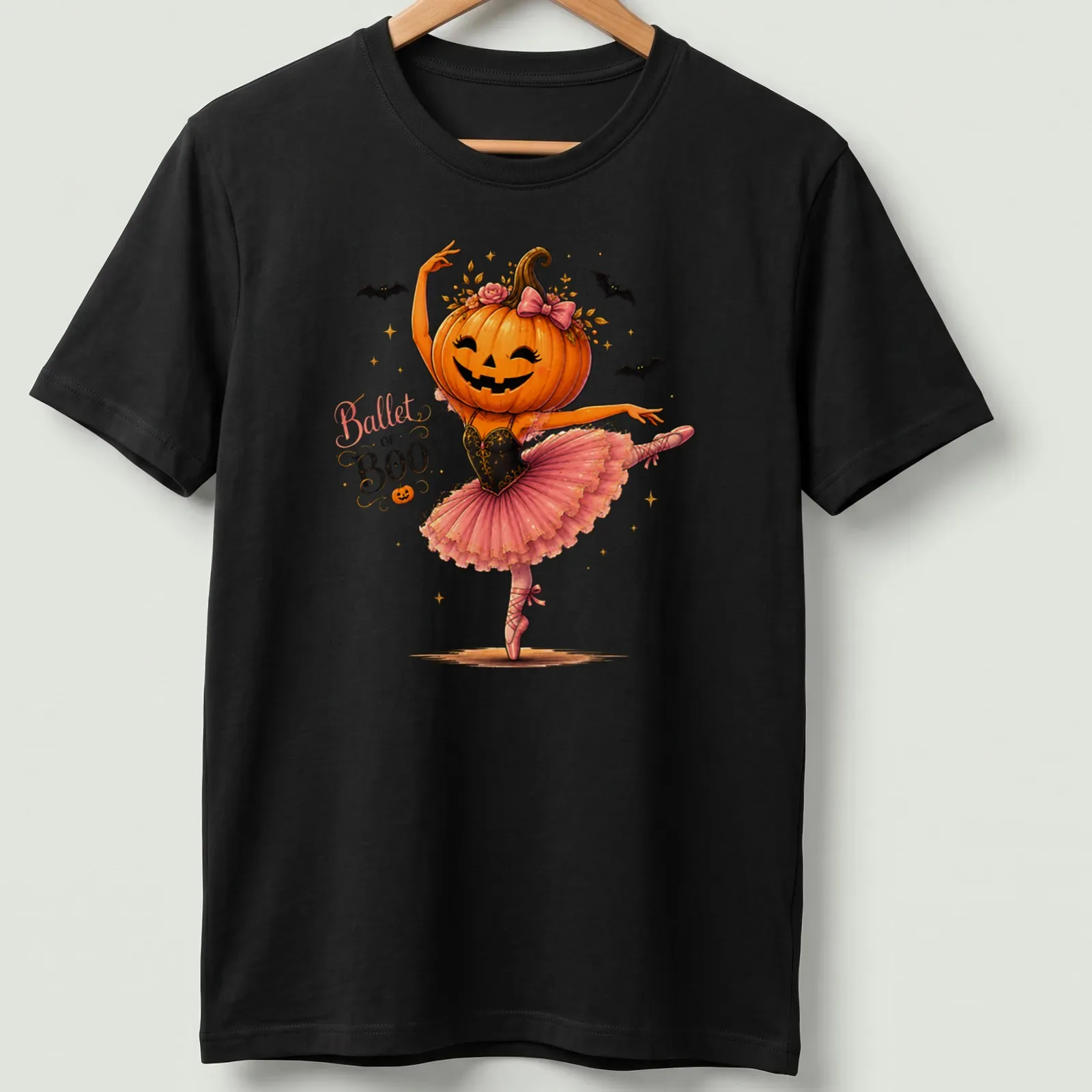 Whimsical illustration of a pumpkin ballerina wearing a pink tutu with the text 'Ballet of Boo' — printed on a unisex t-shirt