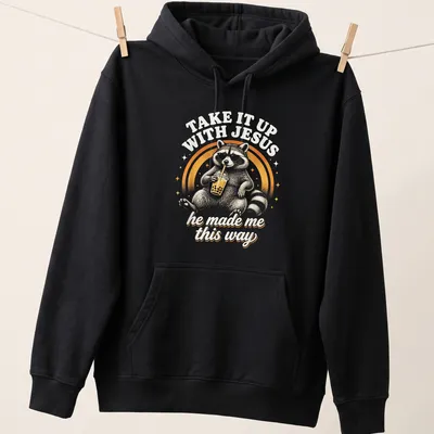 Vintage retro print of a raccoon holding a soda with humorous text — printed on a unisex hoodie