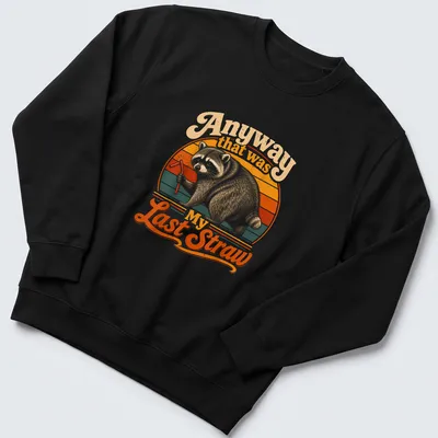 Vintage retro design of a raccoon holding a straw with humorous text above. — printed on a unisex sweatshirt