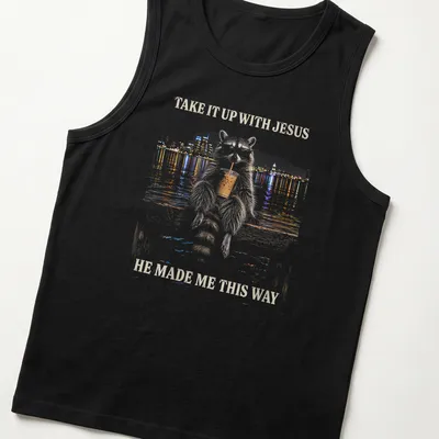 Stylized illustration of a cheeky raccoon with humorous text about Jesus. — printed on a tank top