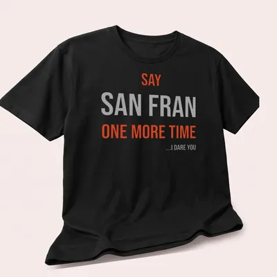 Bold typography t-shirt featuring the phrase 'SAY SAN FRAN ONE MORE TIME ....I DARE YOU' — printed on a unisex t-shirt (angled view)