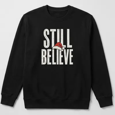 Vintage distressed t-shirt featuring a Santa hat and the phrase 'Still Believe' in bold letters. — printed on a unisex sweatshirt