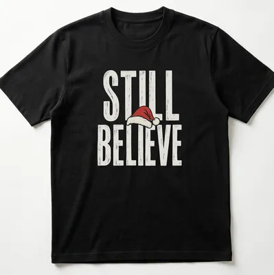 Vintage distressed t-shirt featuring a Santa hat and the phrase 'Still Believe' in bold letters.