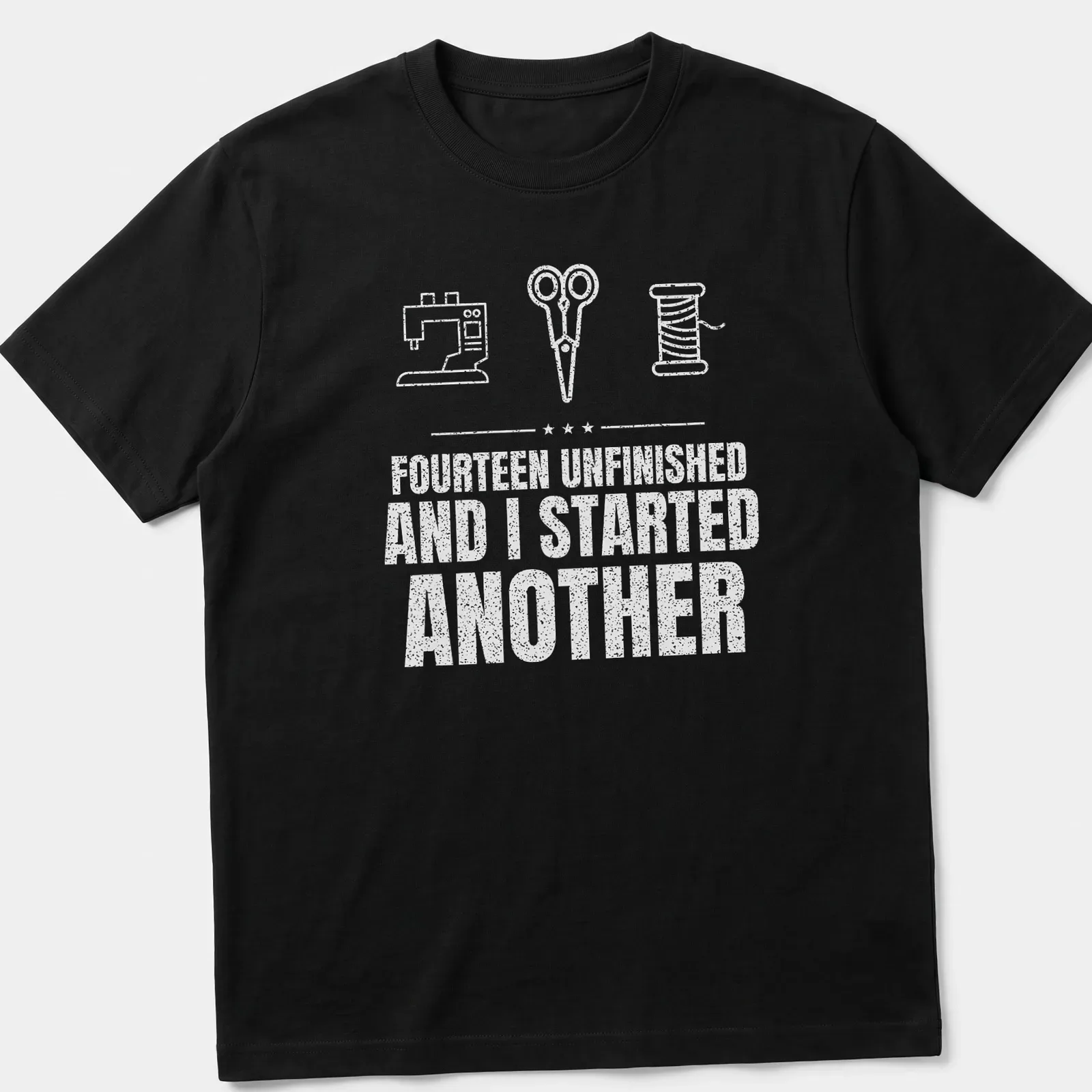 Typography t-shirt featuring a sewing machine, scissors, and a spool with humorous text — printed on a unisex t-shirt