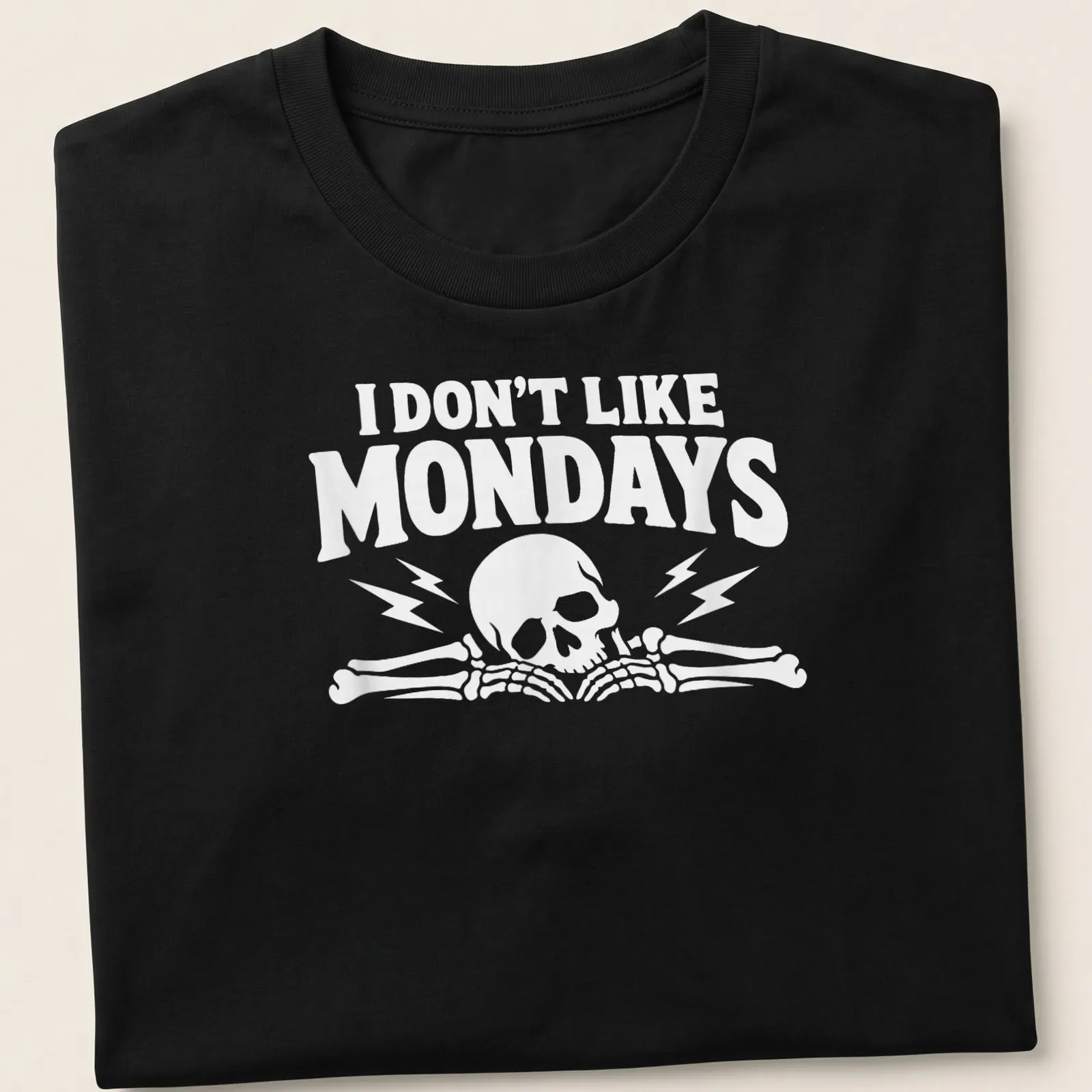 Bold graphic of a skull and bones with text 'I DON'T LIKE MONDAYS' — printed on a unisex t-shirt