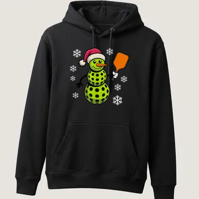 Cartoon snowman playing pickleball in red and green with festive colors — printed on a unisex hoodie