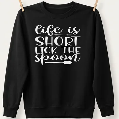 Playful design of a spoon with text 'Life Is Short Lick The Spoon' in black and white. — printed on a unisex sweatshirt