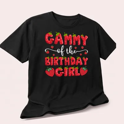 Colorful cartoon design of strawberries and text 'Gammy Birthday Girl' on a — printed on a unisex t-shirt (angled view)
