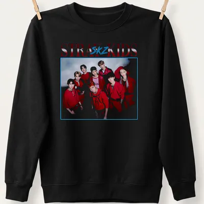 Vintage-inspired Stray Kids t-shirt featuring bold text and a playful design in red, white, and blue. — printed on a unisex sweatshirt