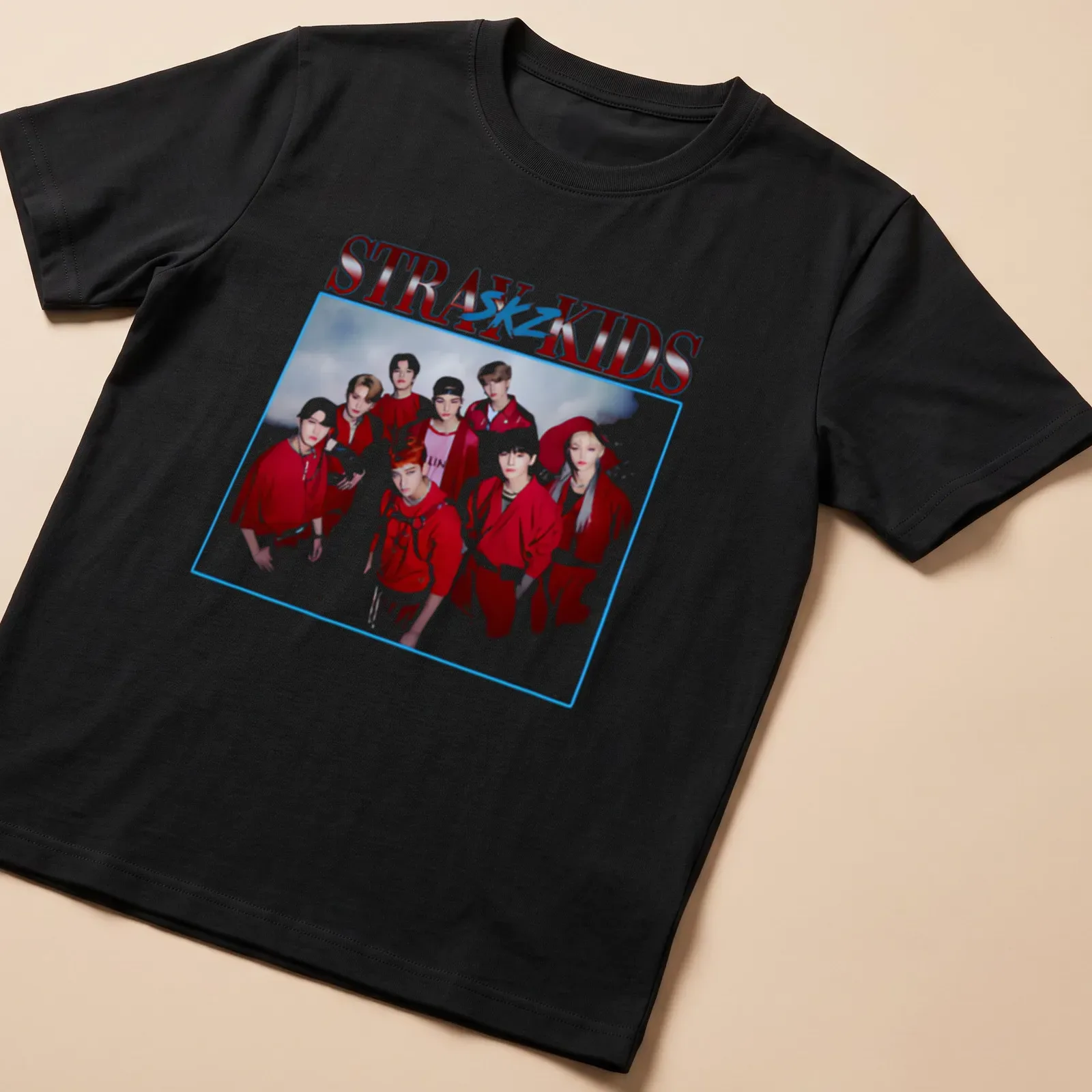 Vintage-inspired Stray Kids t-shirt featuring bold text and a playful design in red, white, and blue. — printed on a unisex t-shirt