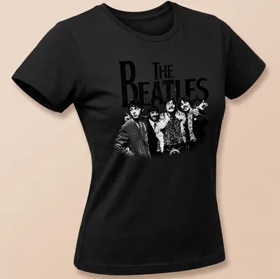 Vintage distressed t-shirt featuring bold text of 'THE BEATLES' in black and white — printed on a women's shirt
