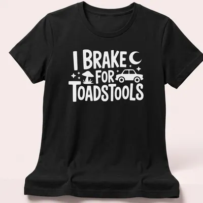 Illustration of red and white toadstools with playful text about braking for them — printed on a women's shirt
