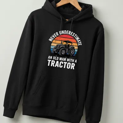 Retro distressed Tractor Driver shirt with colorful text and tractor graphic — printed on a unisex hoodie