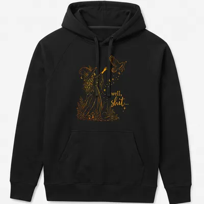 Whimsical illustration of a witch with a crow and magic wand, with text: 'well, shit...' — printed on a unisex hoodie