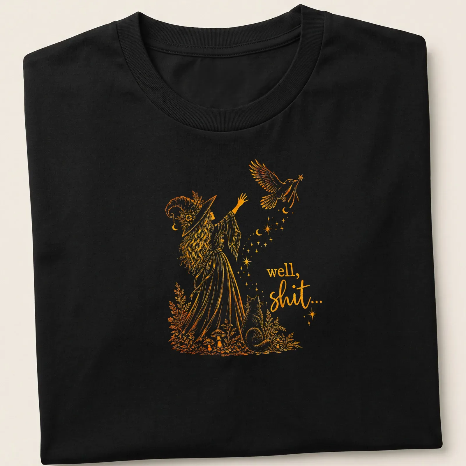 Whimsical illustration of a witch with a crow and magic wand, with text: 'well, shit...' — printed on a unisex t-shirt