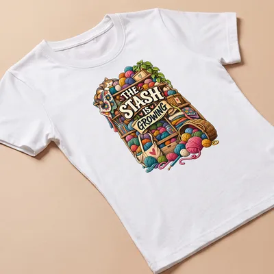 Colorful illustration of a cat surrounded by yarn and knitting supplies with printed text above. — printed on a women's shirt