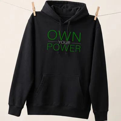 Bold typography shirt with 'OWN YOUR POWER' in dark green and white — printed on a unisex hoodie